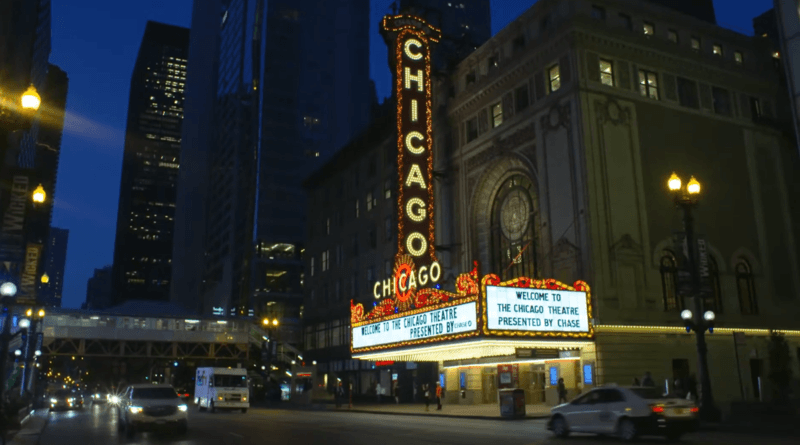 Chicago fall theater night: stage lights over a downtown house, with film-festival and Navy Pier season in the background.